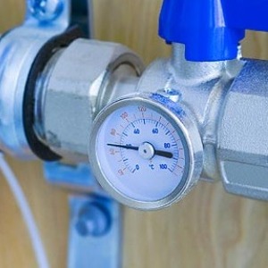 Temperature gauge and blue isolation valve on a heating manifold